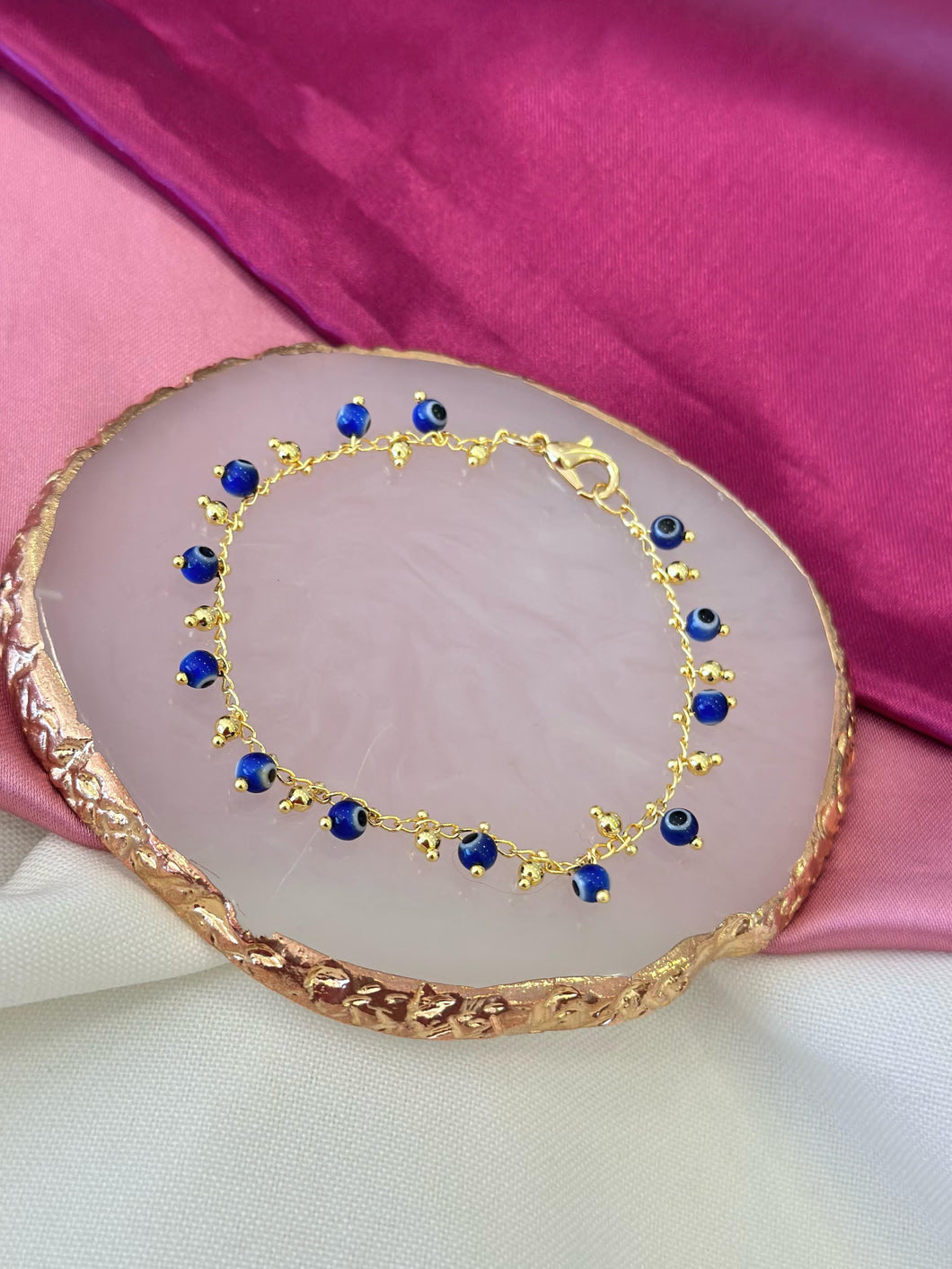Pulsera ojos inflados azules